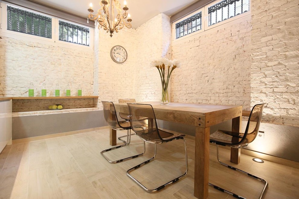 Photo of a mid-sized industrial open plan dining in Madrid with white walls.
