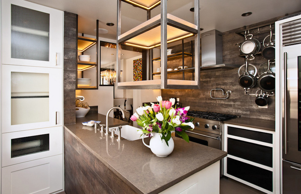 Open concept kitchen - mid-sized transitional galley open concept kitchen idea in Toronto with a farmhouse sink, glass-front cabinets, white cabinets, concrete countertops, gray backsplash, porcelain backsplash, stainless steel appliances and a peninsula