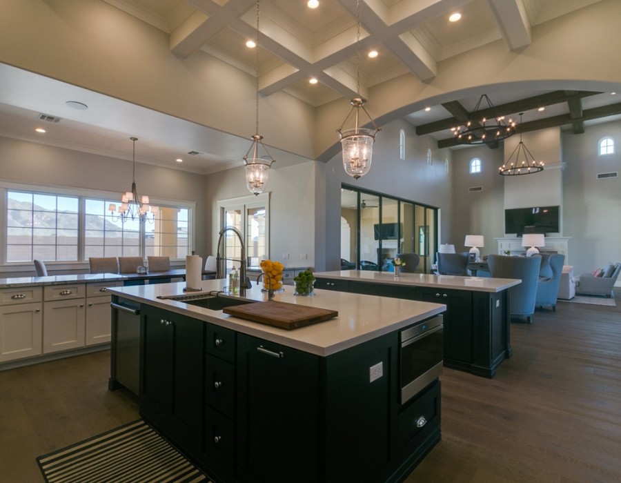 Inspiration for a large transitional l-shaped open plan kitchen in Phoenix with shaker cabinets, white cabinets, quartz benchtops, multiple islands, an undermount sink, white splashback, subway tile splashback, stainless steel appliances, dark hardwood floors and brown floor.