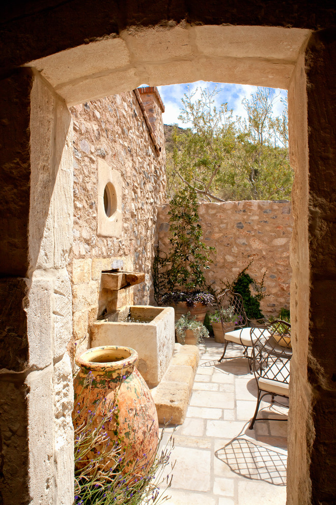 Design ideas for a mediterranean courtyard patio in Phoenix with a water feature.