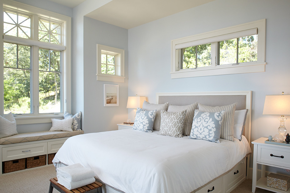 Design ideas for a mid-sized beach style master bedroom in Grand Rapids with blue walls and carpet.