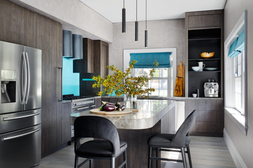 Large contemporary l-shaped eat-in kitchen in Sydney with a drop-in sink, dark wood cabinets, limestone benchtops, with island and grey floor.