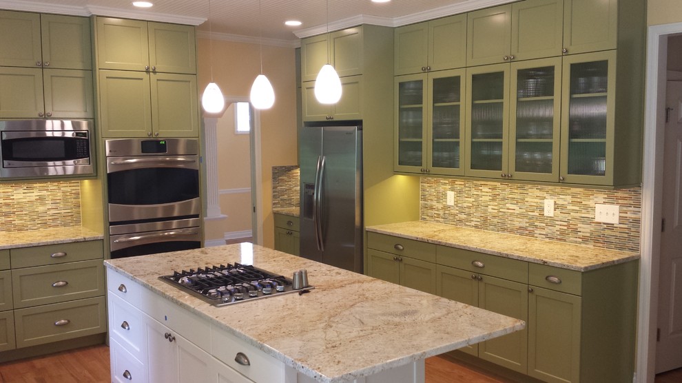 Kitchen - large transitional u-shaped medium tone wood floor kitchen idea in Seattle with a double-bowl sink, recessed-panel cabinets, white cabinets, granite countertops, multicolored backsplash, mosaic tile backsplash, stainless steel appliances and an island