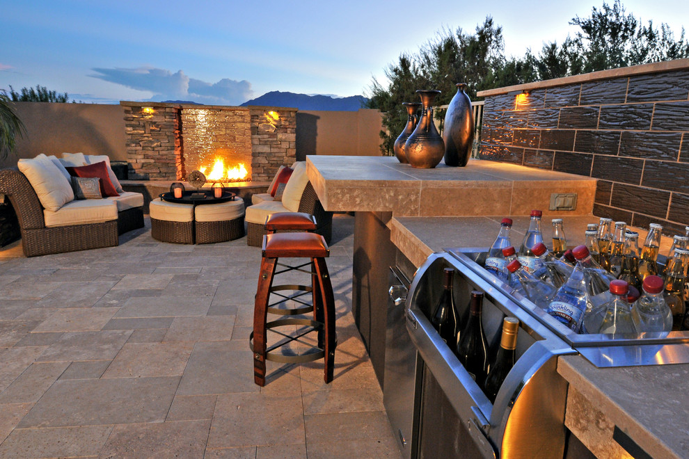 Patio - transitional backyard stone patio idea in Phoenix with a fire pit