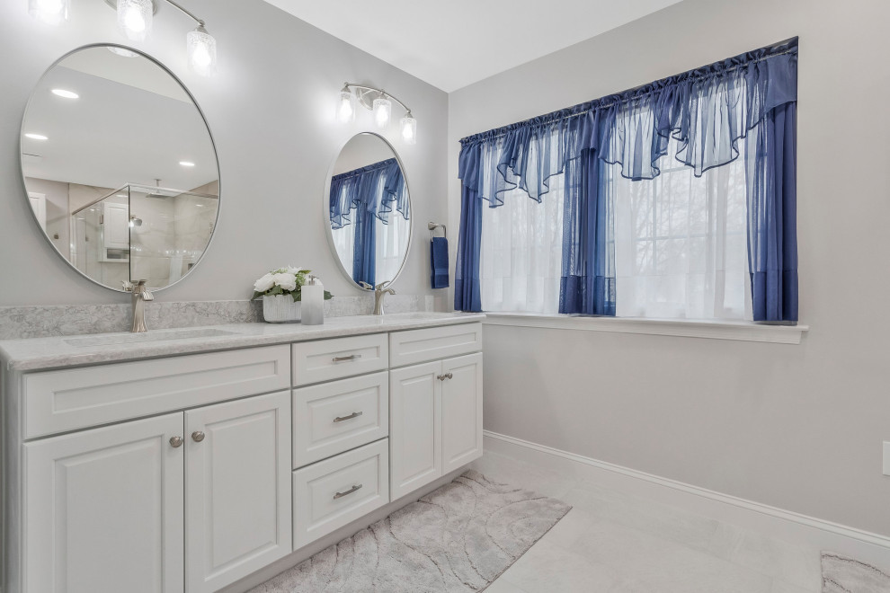 Design ideas for an expansive traditional ensuite bathroom in DC Metro with recessed-panel cabinets, white cabinets, a corner shower, engineered stone worktops, a hinged door, grey worktops, a shower bench, double sinks and a built in vanity unit.