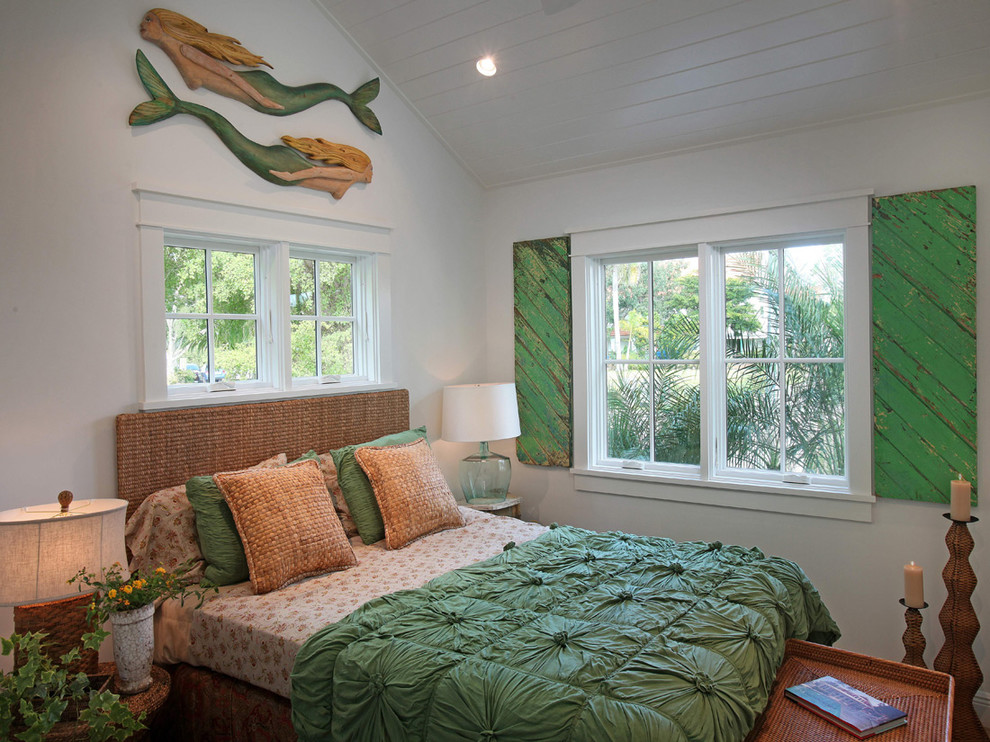 This is an example of a tropical guest bedroom in Miami with white walls.