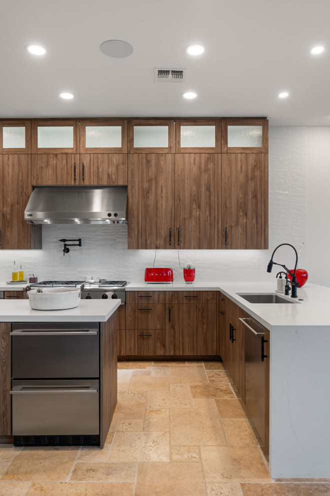 Example of a mountain style l-shaped slate floor and beige floor enclosed kitchen design with a single-bowl sink, flat-panel cabinets, medium tone wood cabinets, quartzite countertops, white backsplash, glass sheet backsplash, stainless steel appliances, a peninsula and white countertops