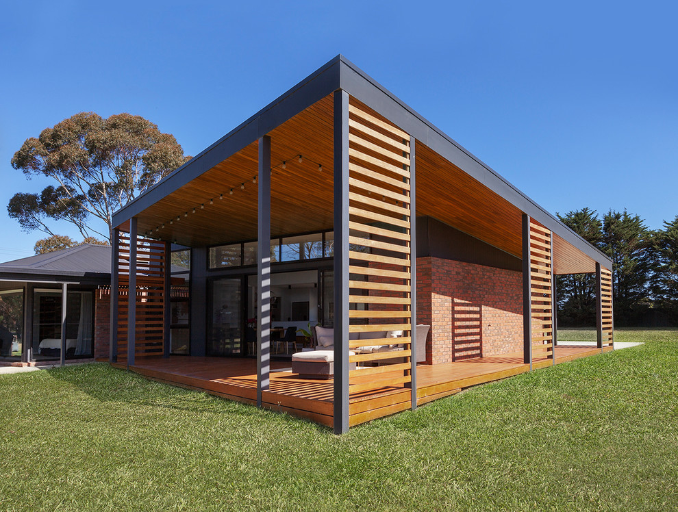 Mid-sized contemporary one-storey black house exterior in Geelong with concrete fiberboard siding and a metal roof.
