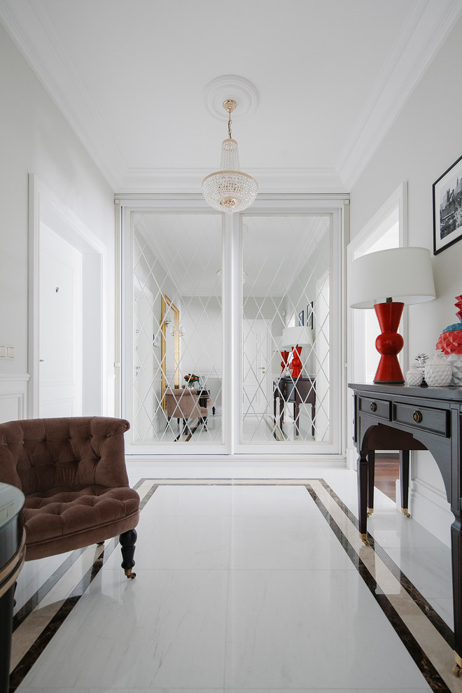 Design ideas for a large transitional hallway in Moscow with white walls and white floor.