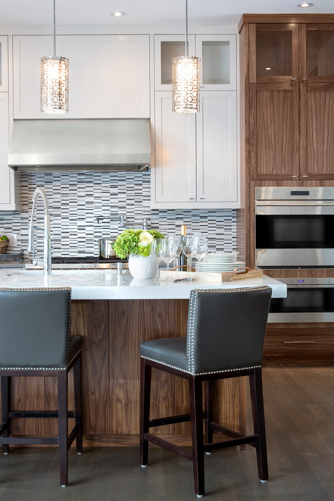 Inspiration for a large transitional l-shaped dark wood floor open concept kitchen remodel in Calgary with an undermount sink, shaker cabinets, white cabinets, quartz countertops, multicolored backsplash, matchstick tile backsplash, stainless steel appliances and an island
