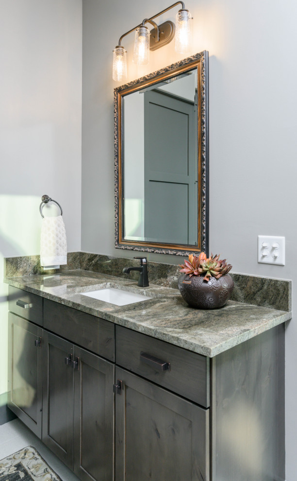 Transitional 3/4 ceramic tile bathroom photo with shaker cabinets, dark wood cabinets, gray walls, an undermount sink and multicolored countertops