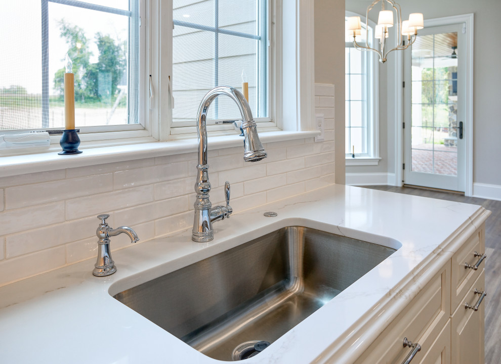 Transitional Kitchen with Two Toned Gathering Island & Archways