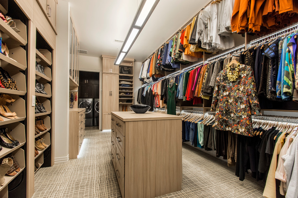 Inspiration for a large transitional gender-neutral walk-in wardrobe in Dallas with shaker cabinets, light wood cabinets and carpet.