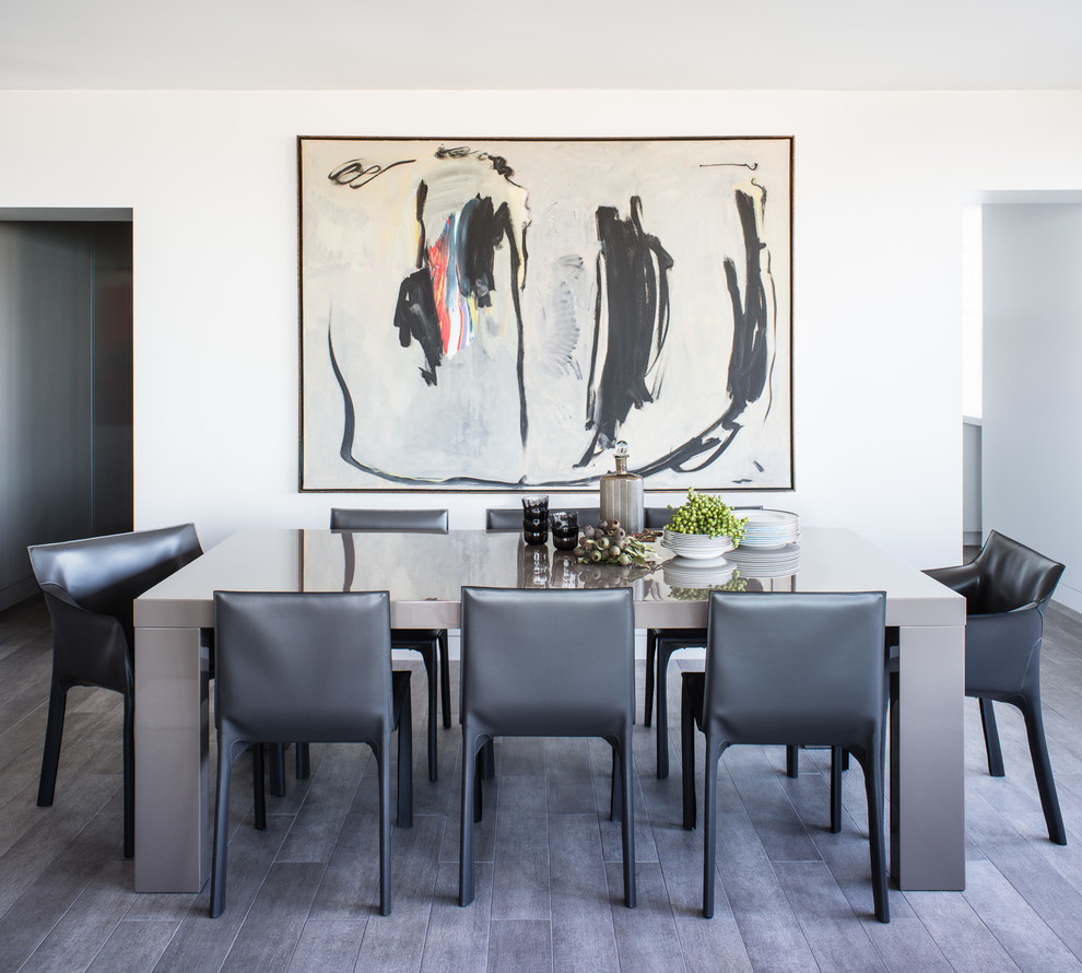This is an example of a contemporary dining room in San Francisco with white walls and grey floor.