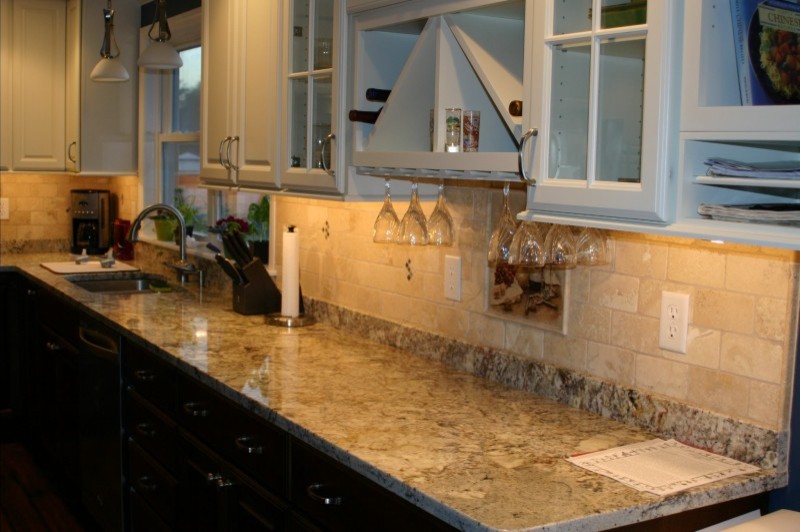 Example of a large transitional l-shaped dark wood floor open concept kitchen design in Providence with an undermount sink, glass-front cabinets, white cabinets, granite countertops, beige backsplash, subway tile backsplash, stainless steel appliances and an island