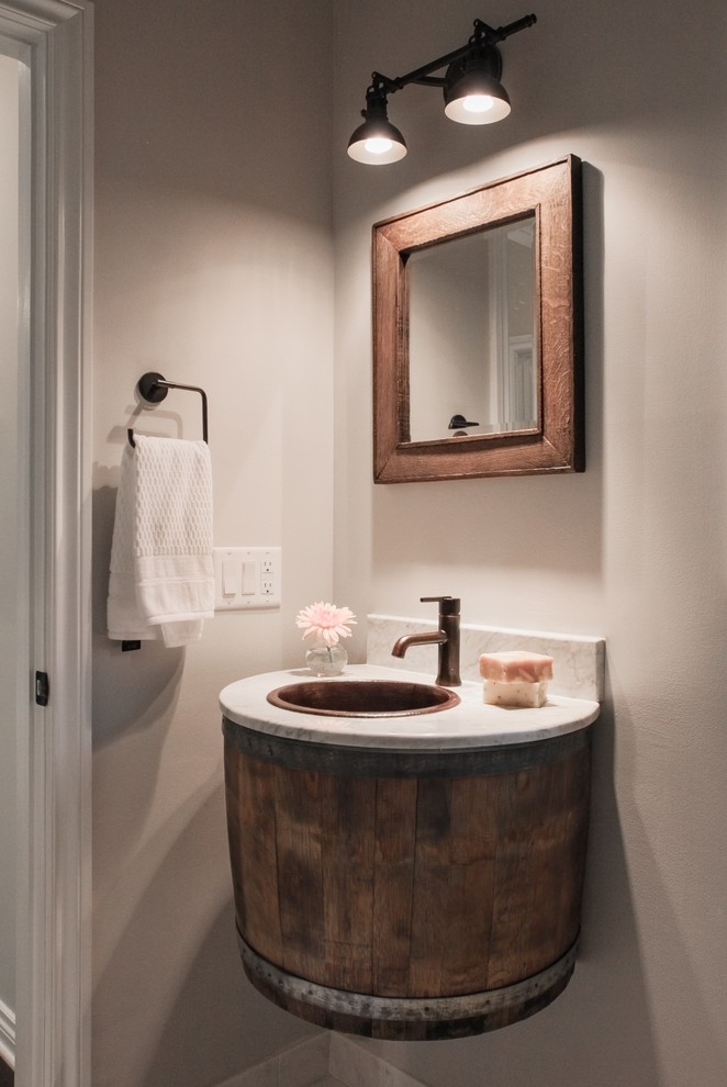 Photo of a small country bathroom in Grand Rapids with open cabinets, distressed cabinets, an alcove tub, a shower/bathtub combo, a two-piece toilet, white tile, grey walls, marble floors, a drop-in sink and marble benchtops.