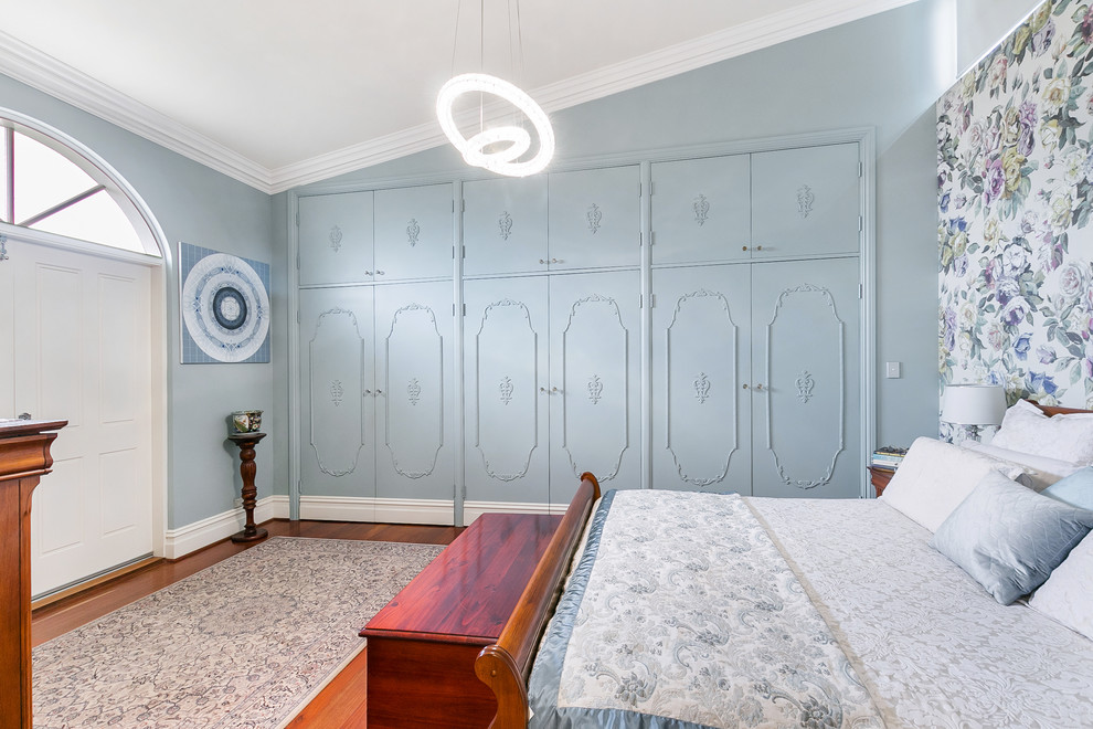 Design ideas for a transitional bedroom in Perth with blue walls, medium hardwood floors and no fireplace.