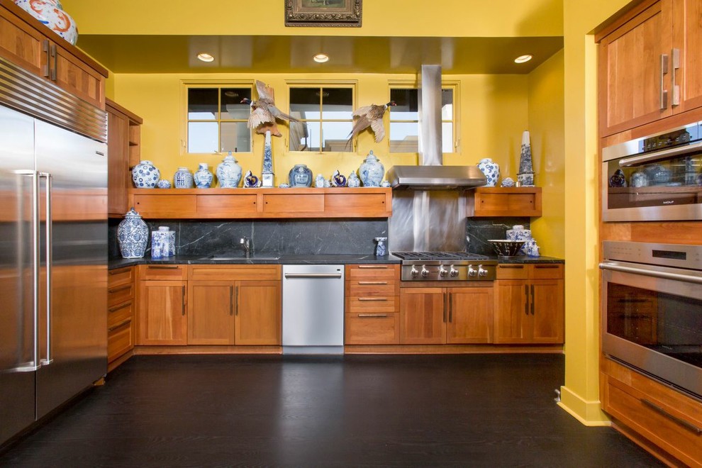 Photo of an eclectic kitchen in Santa Barbara with stone slab splashback and medium wood cabinets.