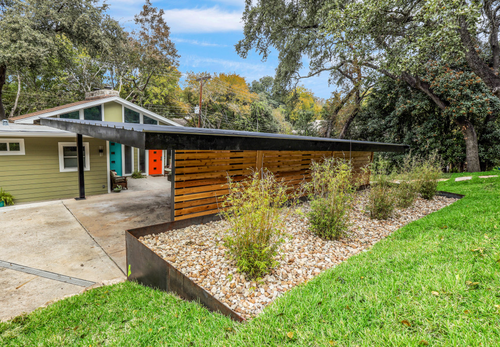 Photo of a large contemporary detached two-car carport in Austin.