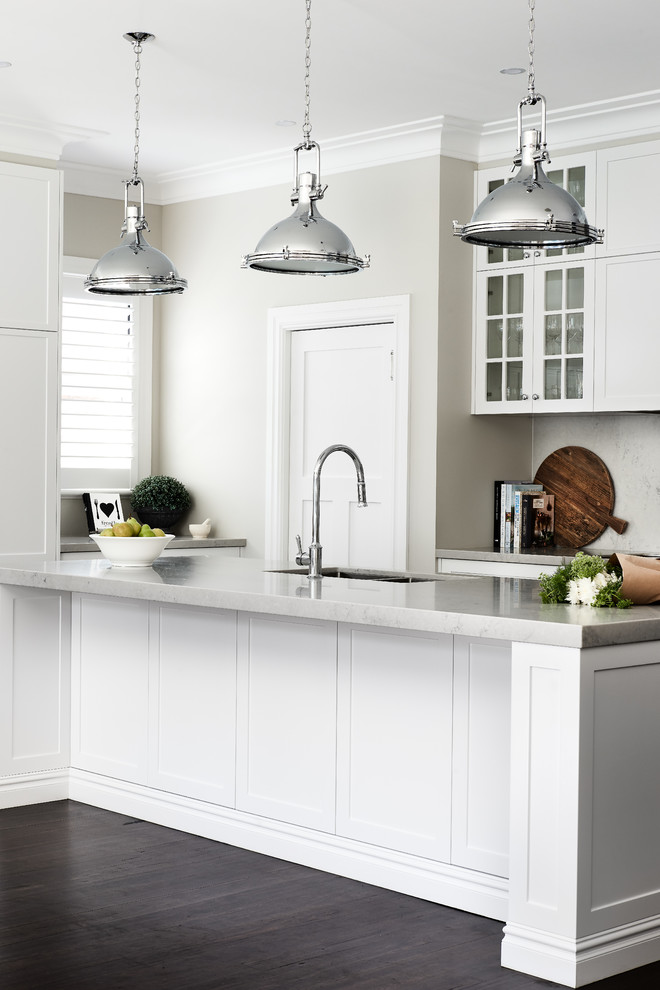 Inspiration for a transitional kitchen pantry in Sydney with a double-bowl sink, shaker cabinets, white cabinets, quartz benchtops, grey splashback, dark hardwood floors, with island, brown floor and grey benchtop.