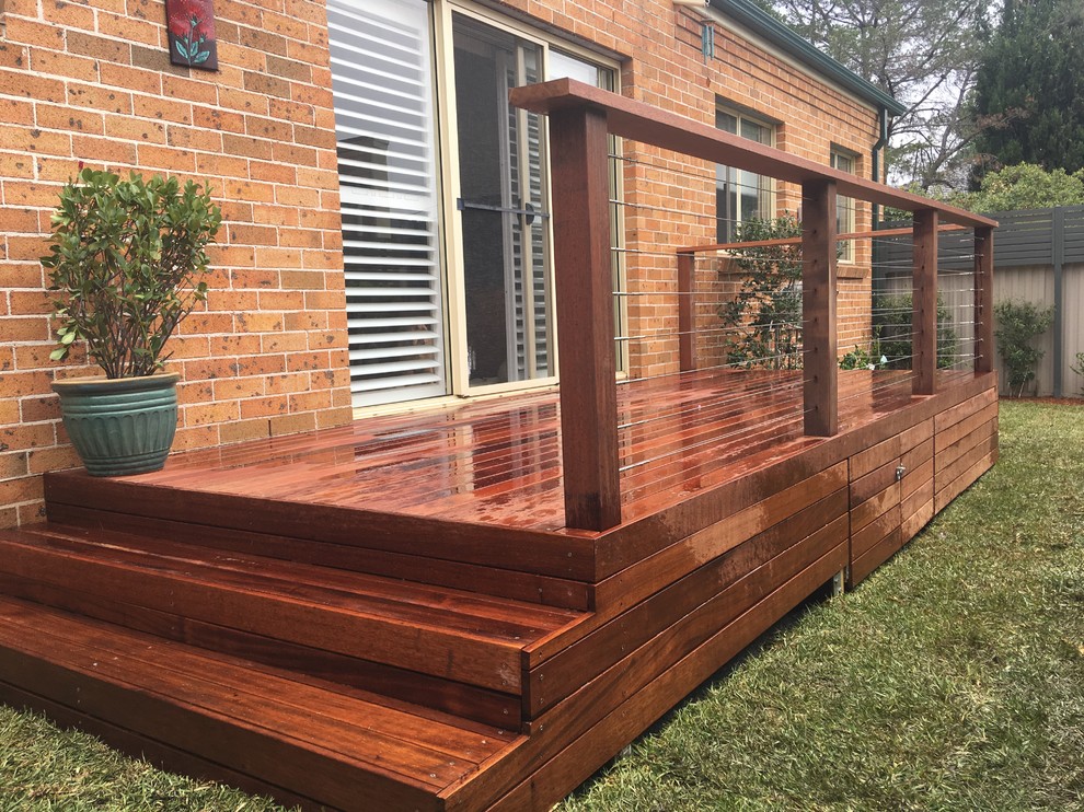 This is an example of a mid-sized contemporary backyard deck in Sydney with no cover.