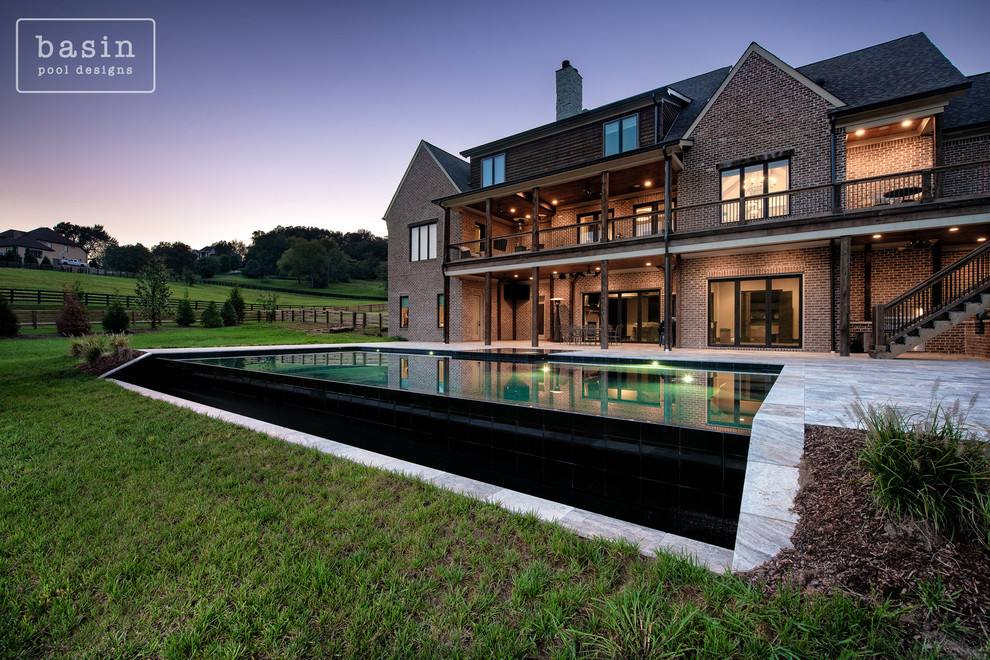 Hot tub - large transitional backyard stone and custom-shaped infinity hot tub idea in Nashville