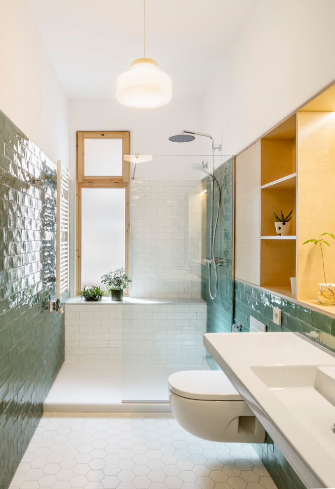 Design ideas for a small scandinavian master bathroom in Barcelona with open cabinets, white cabinets, an open shower, a wall-mount toilet, green tile, ceramic tile, green walls, ceramic floors, a wall-mount sink, white floor and an open shower.