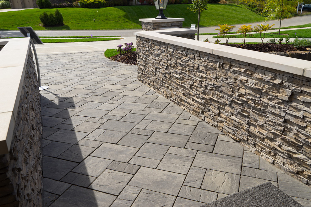 Photo of a large transitional partial sun front yard mulch retaining wall landscape.