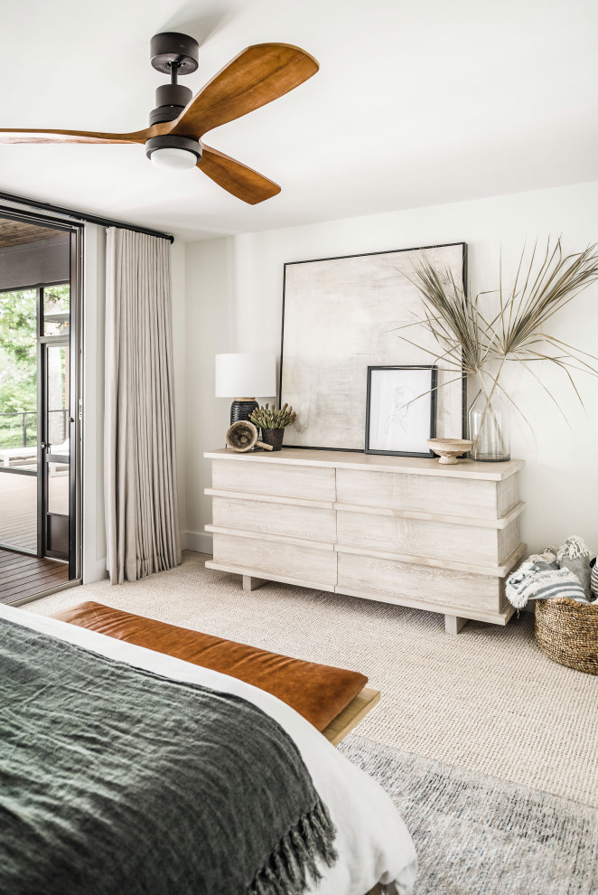 Mid-sized beach style master bedroom in Charlotte with white walls, carpet and beige floor.