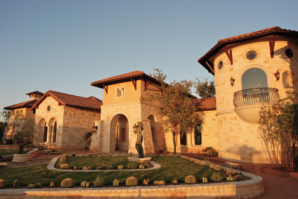 Photo of a mid-sized country two-storey beige exterior in Austin with stone veneer and a gable roof.