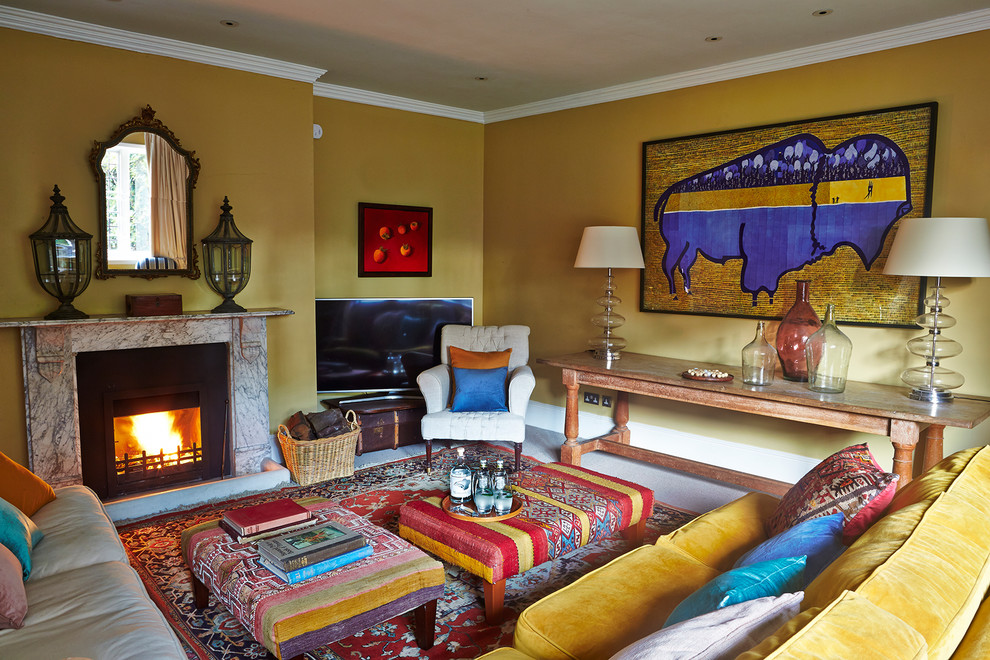 This is an example of a large eclectic enclosed living room in Hampshire with yellow walls, carpet, a standard fireplace, a stone fireplace surround and a freestanding tv.
