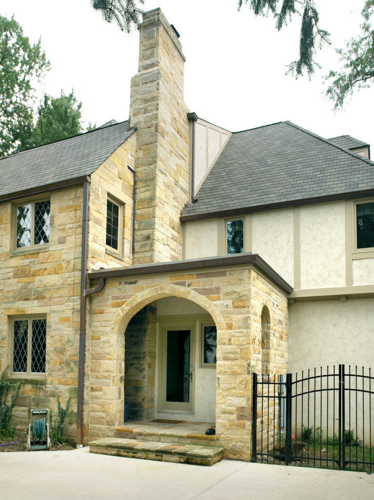 Inspiration for a mid-sized traditional two-storey beige exterior in Columbus with stone veneer.