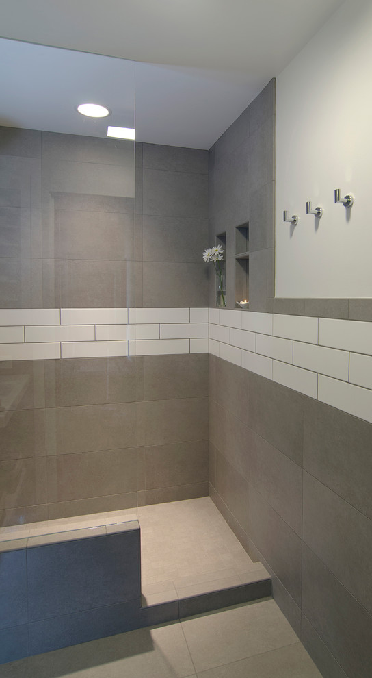 This is an example of a small modern 3/4 bathroom in Cincinnati with open cabinets, white cabinets, an open shower, ceramic tile, white walls, ceramic floors, a wall-mount sink, grey floor, an open shower, gray tile and engineered quartz benchtops.