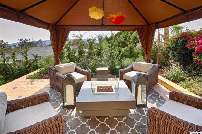 Inspiration for a mid-sized backyard patio in Los Angeles with tile and a gazebo/cabana.