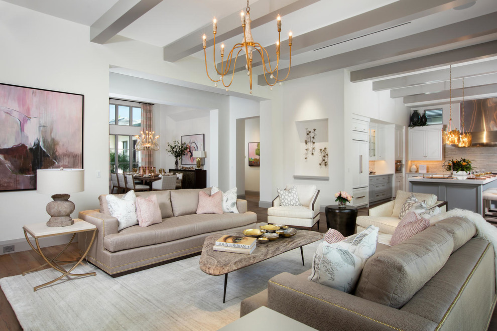 This is an example of a transitional open concept living room in Miami with white walls.