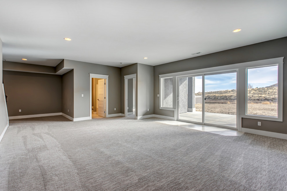 Mid-sized transitional walk-out carpeted and gray floor basement photo in Seattle with gray walls and no fireplace