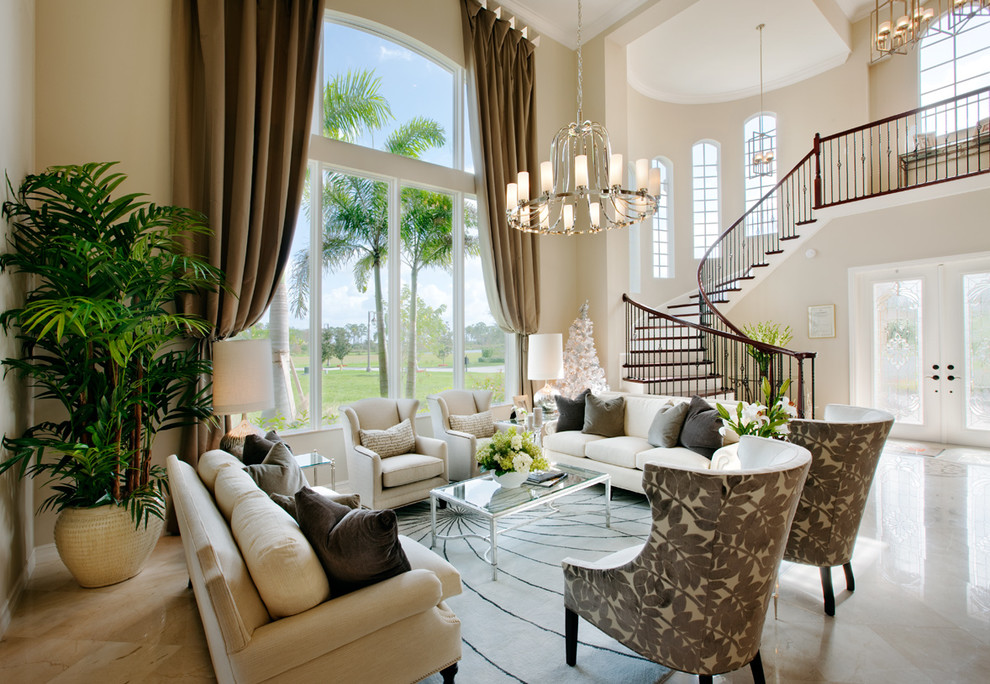 This is an example of a large traditional formal open concept living room in Miami with beige walls, marble floors and no tv.