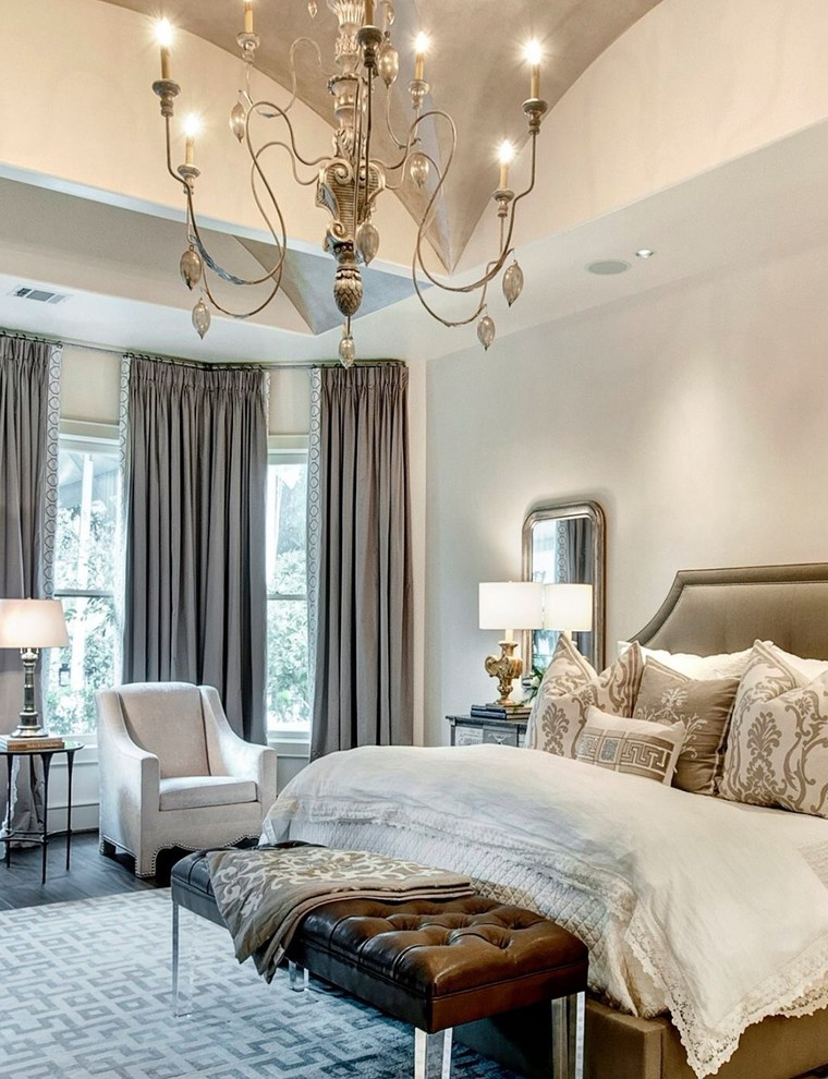 Design ideas for a large transitional master bedroom in Houston with beige walls and dark hardwood floors.