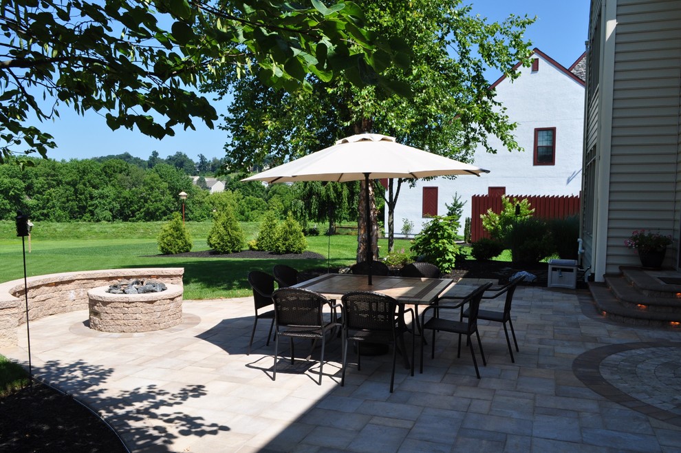 Patio - mid-sized traditional backyard concrete paver patio idea with a fire pit and no cover