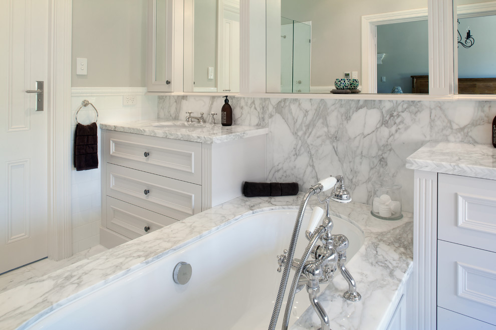 Design ideas for a large traditional master bathroom in Perth with recessed-panel cabinets, white cabinets, marble benchtops, an undermount tub, grey walls, marble floors, gray tile, marble, grey floor and grey benchtops.