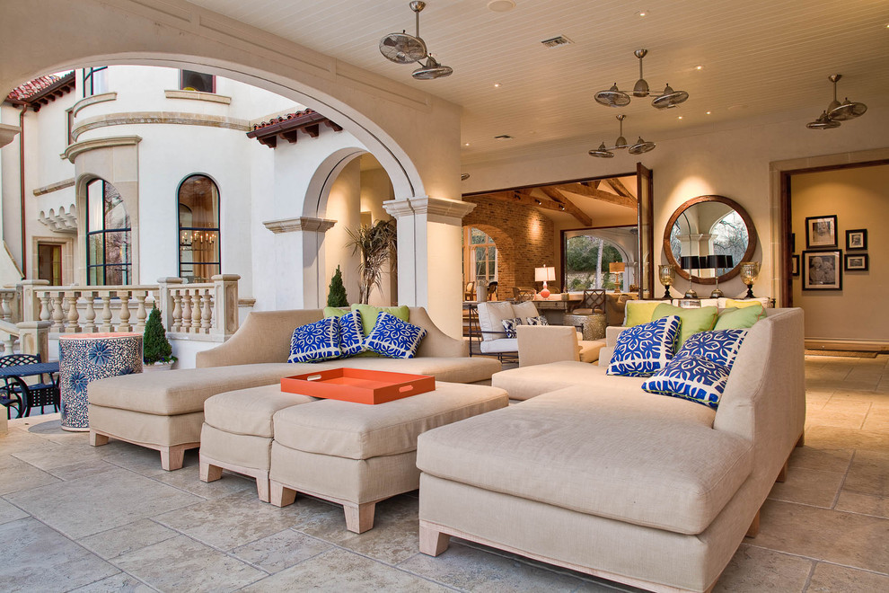 This is an example of a mediterranean patio in Dallas with a roof extension.