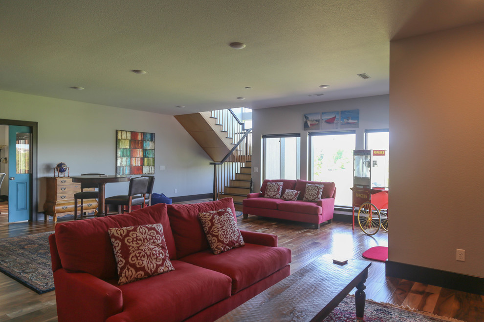 Inspiration for a large transitional open concept medium tone wood floor home design remodel with a bar, white walls, no fireplace and a wall-mounted tv