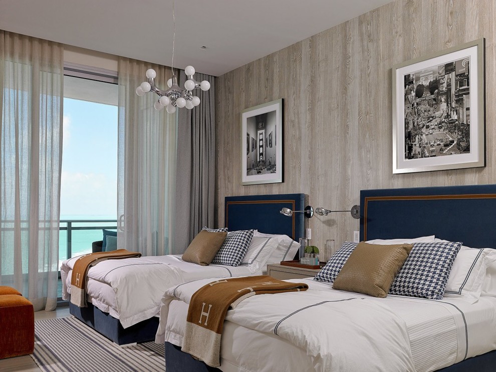 This is an example of a large beach style guest bedroom in Miami with brown walls, carpet, no fireplace and grey floor.