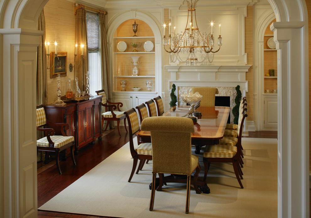 Inspiration for a large traditional separate dining room in Philadelphia with yellow walls, medium hardwood floors, a standard fireplace and a stone fireplace surround.