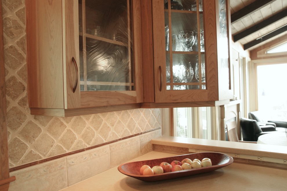 Inspiration for a mid-sized transitional l-shaped medium tone wood floor enclosed kitchen remodel in San Francisco with an undermount sink, shaker cabinets, medium tone wood cabinets, granite countertops, beige backsplash, stone tile backsplash and stainless steel appliances