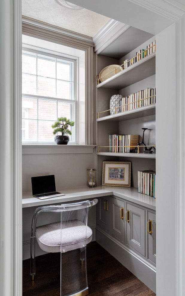 Inspiration for a small transitional built-in desk dark wood floor, brown floor and wallpaper ceiling home office library remodel in Boston with gray walls