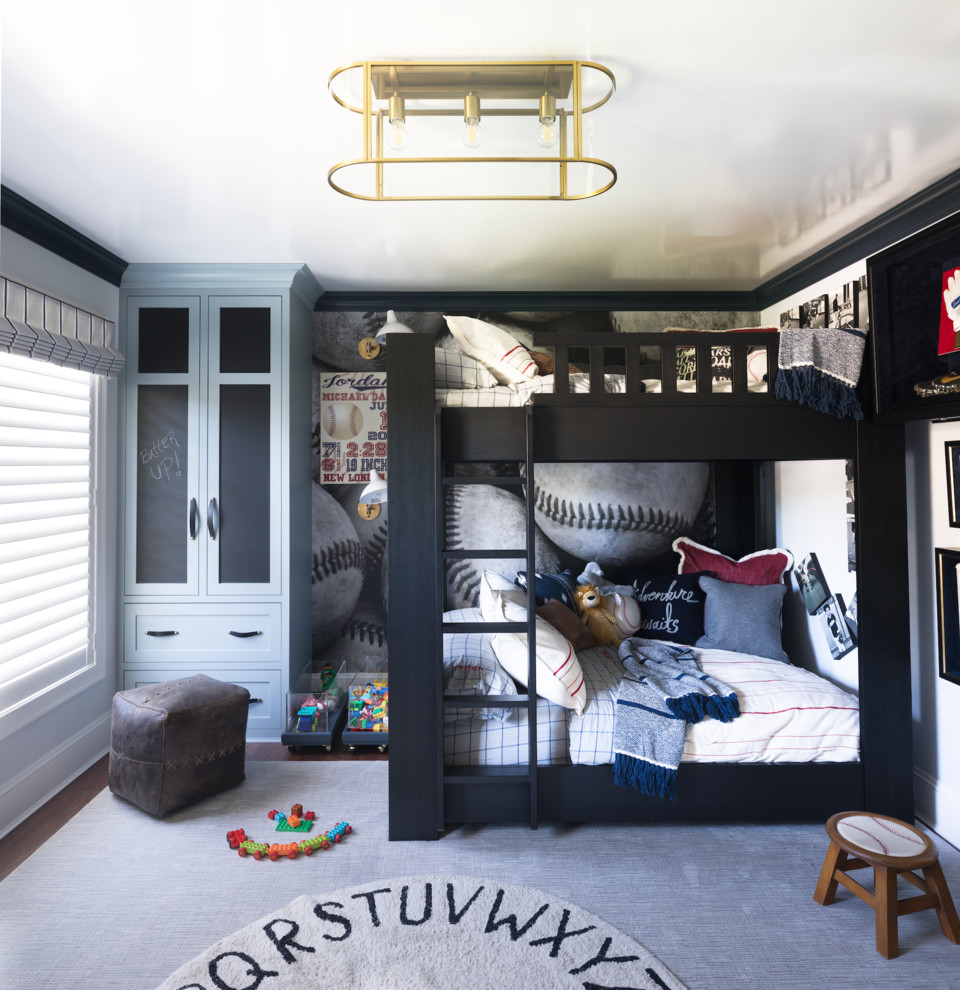 Design ideas for a mid-sized transitional kids' bedroom for kids 4-10 years old and boys in New York with white walls, medium hardwood floors and brown floor.