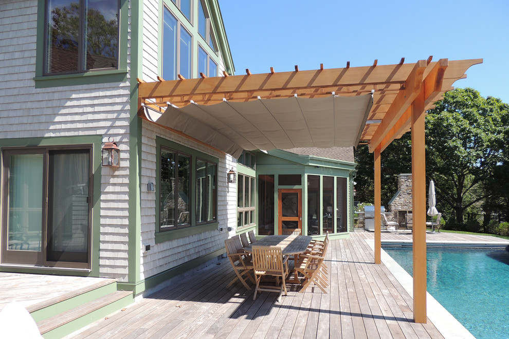 Inspiration for a large beach style backyard deck in Toronto with a pergola.