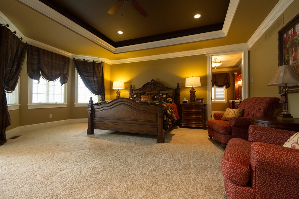 Photo of a large traditional master bedroom in Other with beige walls, carpet and no fireplace.