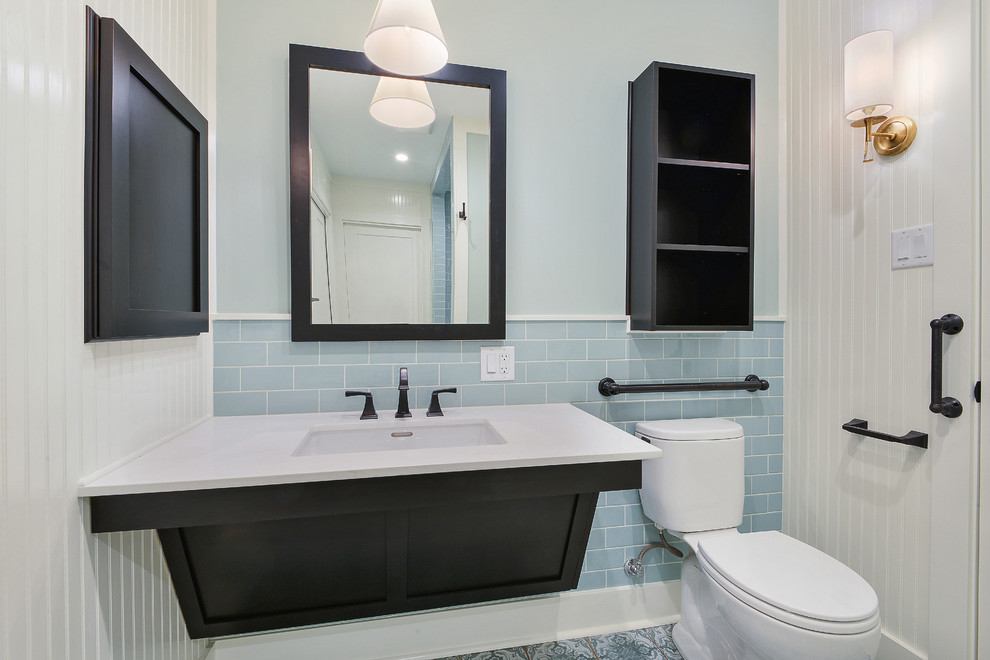 This is an example of a mid-sized modern master bathroom in New Orleans with shaker cabinets, dark wood cabinets, a curbless shower, a two-piece toilet, white tile, subway tile, multi-coloured walls, porcelain floors, an undermount sink, quartzite benchtops, multi-coloured floor and an open shower.